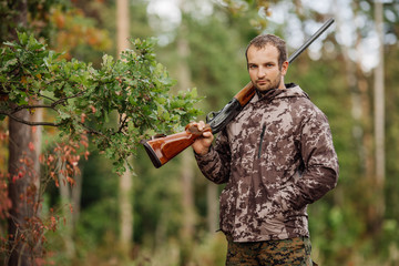 Young male hunter in camouflage clothes ready to hunt  with hunt