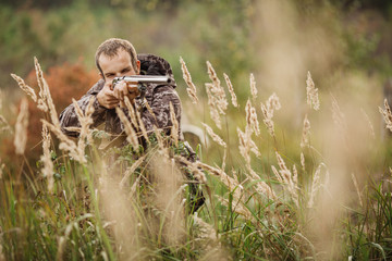 Young male hunter in camouflage clothes ready to hunt  with hunt