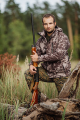 Young male hunter in camouflage clothes ready to hunt  with hunt