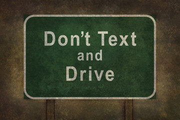 Don’t Text and Drive roadside sign, with ominous background