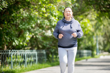 Mature woman jogging in the park. Healthy lifestyle