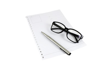 Black glasses and pen on blank piece of paper