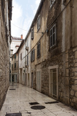 Small and empty alley or pedestrian street at the old town in Split, Croatia.