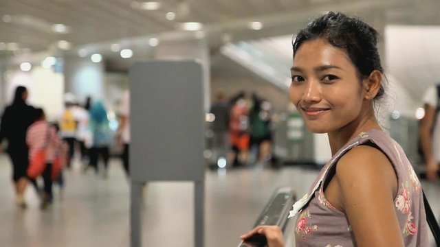 woman rotates on a movable walkway