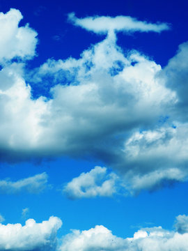 White and grey clouds in blue sky.