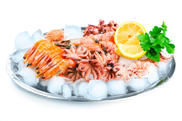 Seafood with lemon and ice on metal tray isolated on white