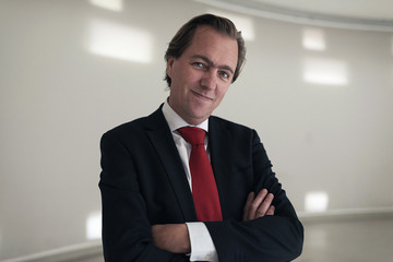Fototapeta premium Happy young entrepreneur wearing red tie in empty room.