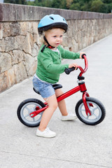 Little kid riding his bike down