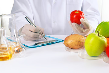 Scientist examines vegetables in laboratory