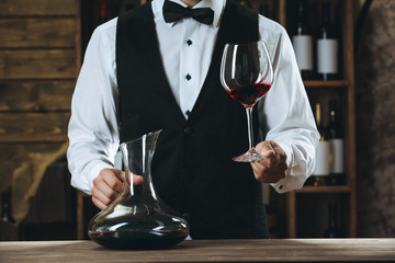 Bartender working at counter on bar background