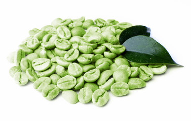 Green coffee beans with leaves isolated on white