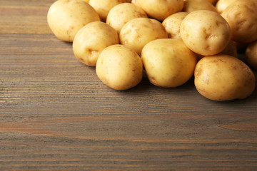 New potatoes on wooden background