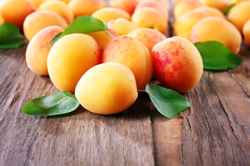 Ripe apricots on wooden table, closeup