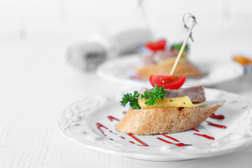 Tasty canapes on wooden table, close up