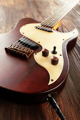 Fototapeta na wymiar Electric guitar on wooden table close up