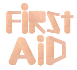 health care concept - text "first aid" written with adhesive pla