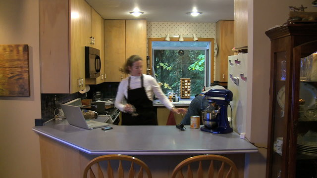 MWS couple in aprons cooking with computer