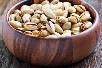 Pistachios nuts on a wooden table.Selective focus.