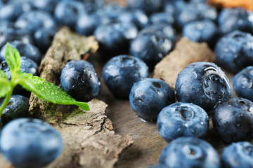 Tasty ripe blueberries on wooden table close up