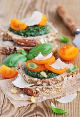Whole grain bread with pesto,tomatoes and Parmesan.Selective focus