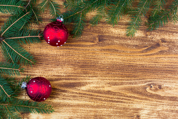 Christmas fir tree with red christmas ball on rustic wooden boar