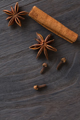 cinnamon and anise on the wooden background