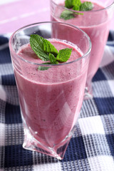Delicious berry smoothie with blackberries on table close up
