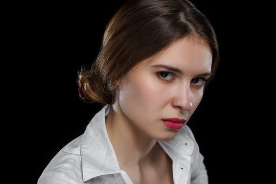 Young casual woman isolated over black background