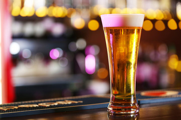Cold beer glass on bar or pub desk