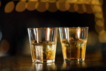 Whiskey glass tumbler standing on bar counter