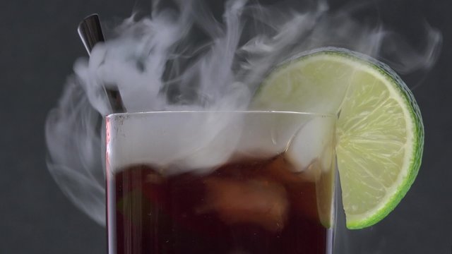 Cuba libre and dry ice smoke/close-up with black background