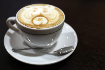 Cup of coffee on wooden table close up