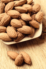 Almonds on wooden spoon