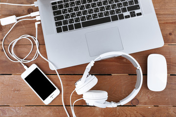 Computer peripherals and laptop accessories on wooden background