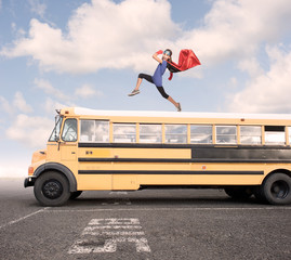 little girl wearing a superhero costume on a school bus. Back to school concept