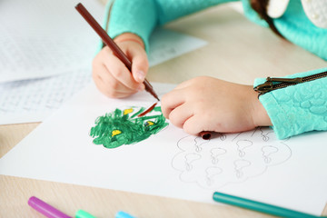 Cute little girl doing her homework, close-up