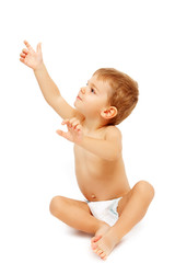 Baby boy in pampers pointing and looking up