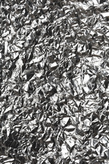 Silver wrinkled and shrunken foil surface, crinkly, crushed metallic background