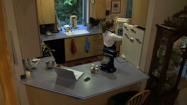 HS cooking, consulting computer on counter