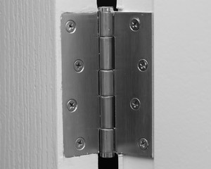 Naklejka premium close up view of stainless door hinges on a white door