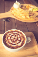 Latte Coffee art on the wooden desk vintage color