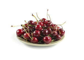 Green ceramic plate with ripe cherry isolated on white