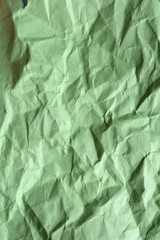 Green crumpled paper for background. Textured grunge surface for design.