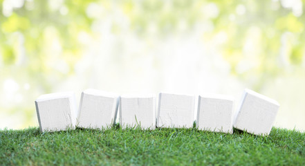 Wooden blocks on a green grass