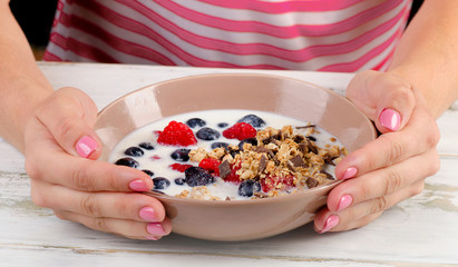 Yogurt with fresh berries, cereals and muesli.