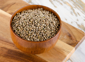 Hemp seeds on  wooden table.