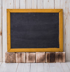 Black chalkboard on wooden background, horizontally placed