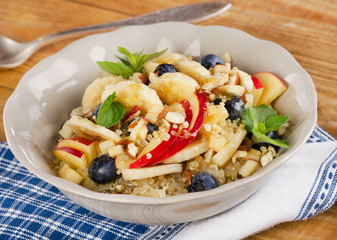 Healthy breakfast quinoa with blueberries, banana, almond and ho