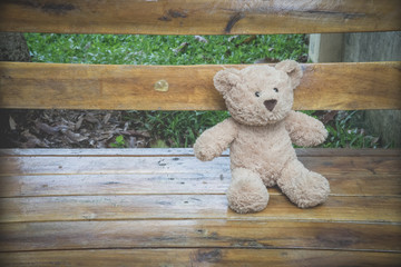 a teddybear on a bench