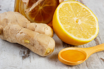 Fresh lemon, honey and ginger on wooden table, healthy nutrition